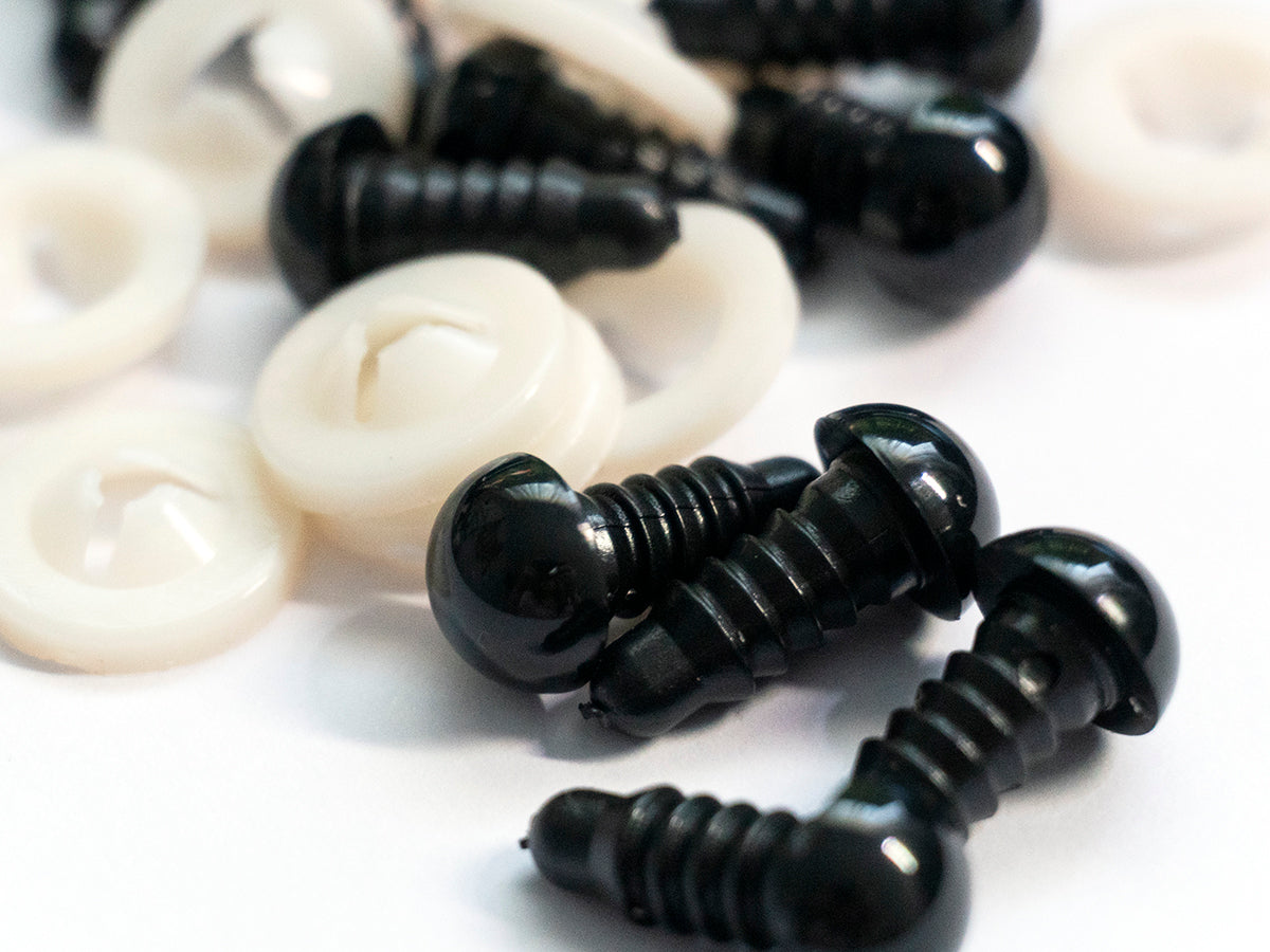 9 mm black safety eyes used for amigurumi laying on a table