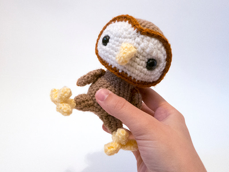 amigurumi crochet barn owl pattern in hand for size comparison