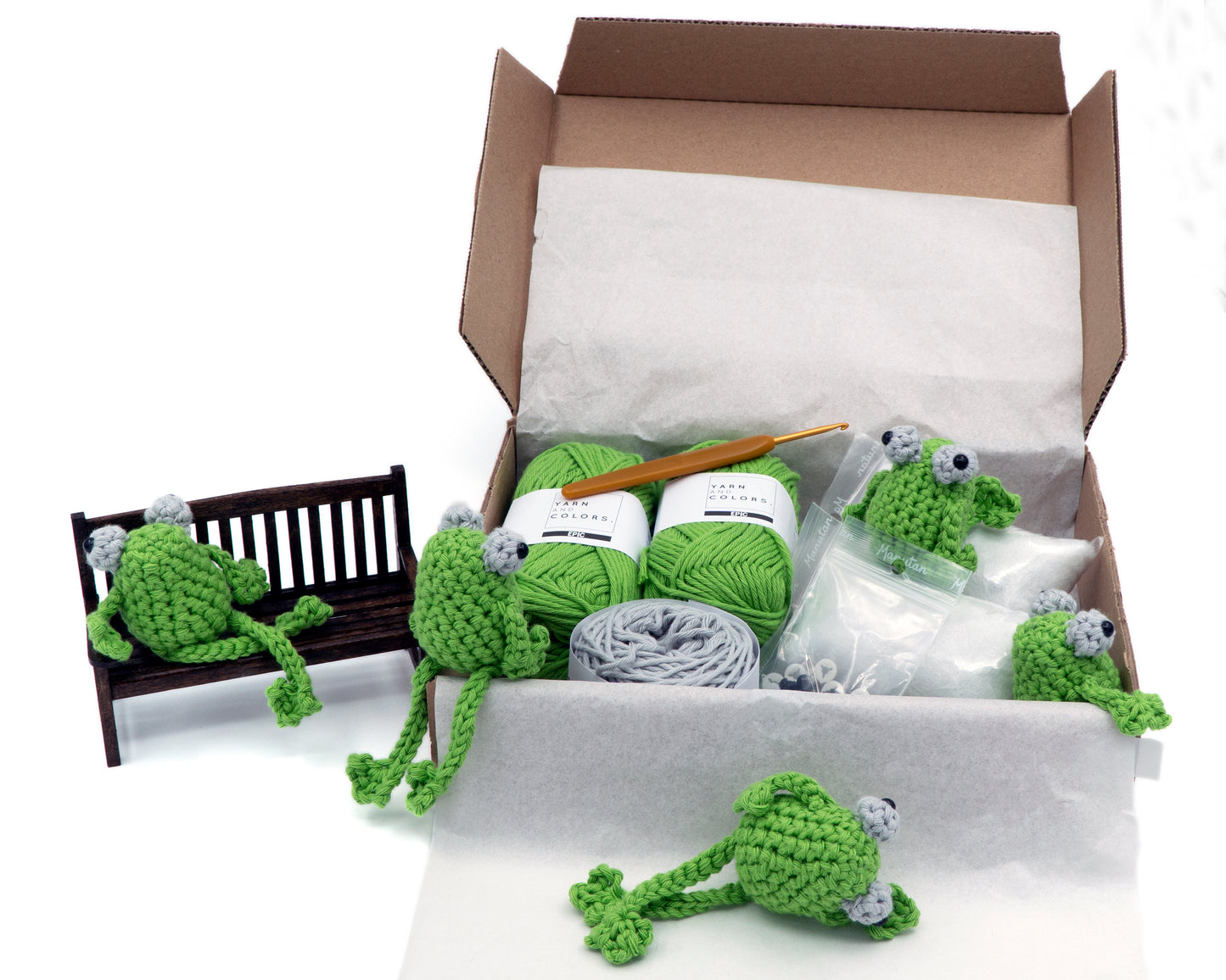 amigurumi crochet sitting frog kit with little frogs sitting inside the kit box