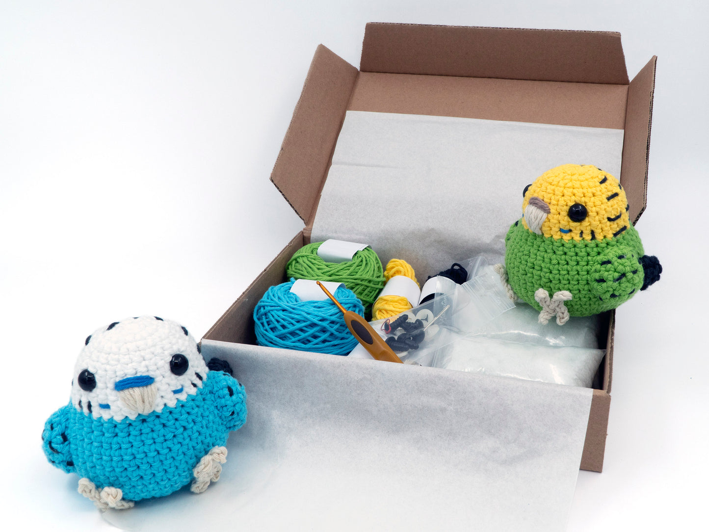 amigurumi crochet budgie kit two parakeets sitting inside a box of yarn