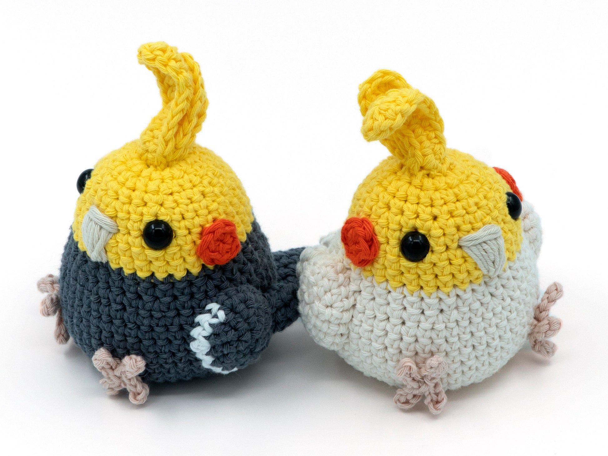amigurumi crochet cockatiel pattern grey and lutino birds facing away from each other