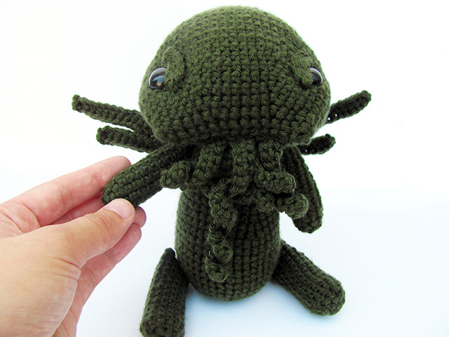 amigurumi crochet cthulhu scarf and plush pattern bundle with plush in hand for size comparison