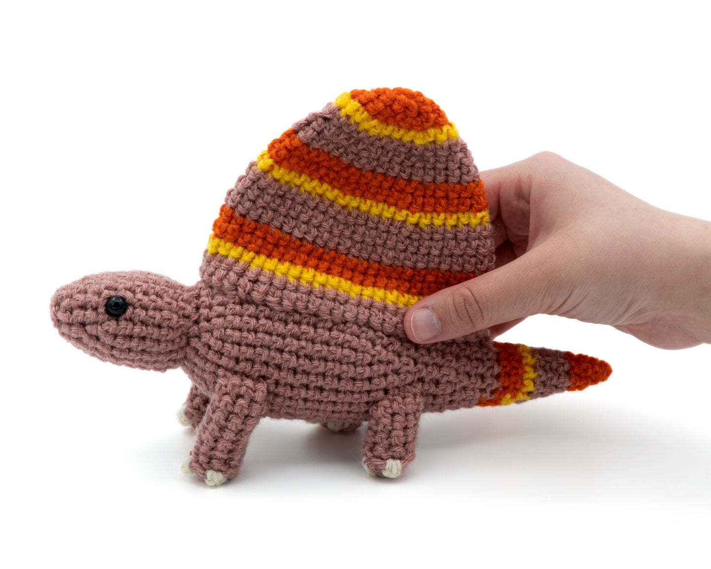 amigurumi crochet dimetrodon dinosaur pattern in hand for size comparison