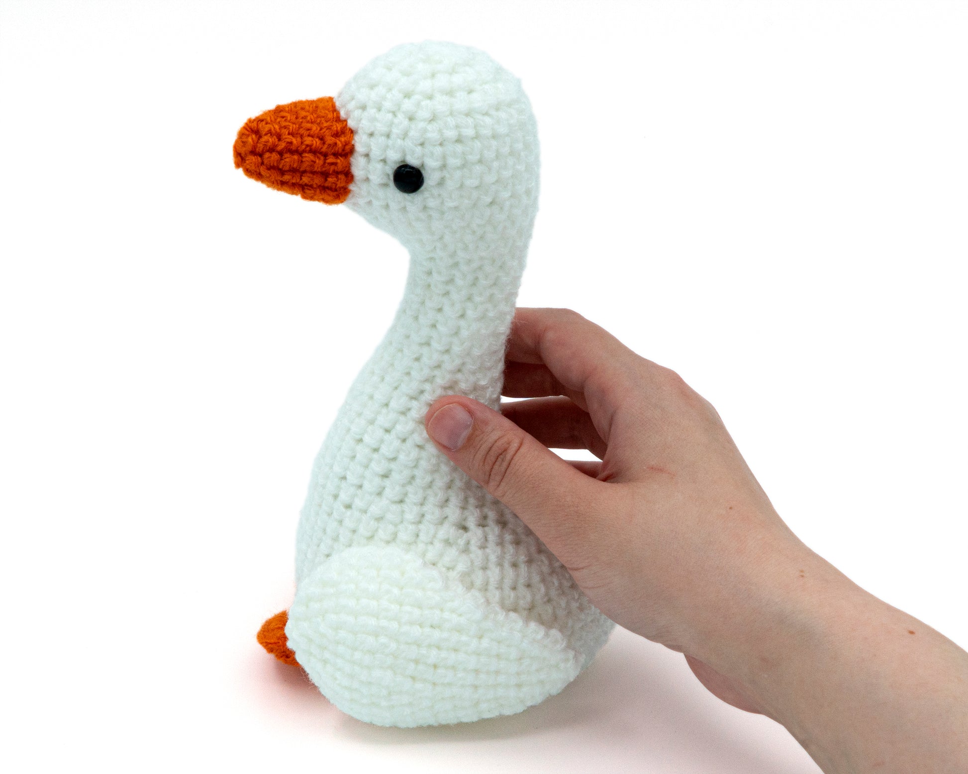 amigurumi crochet goose family pattern in hand for size comparison