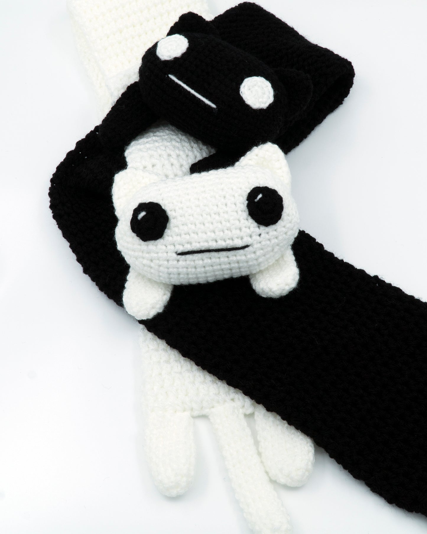 amigurumi crochet longcat pattern next to tacgnol scarf twisting together