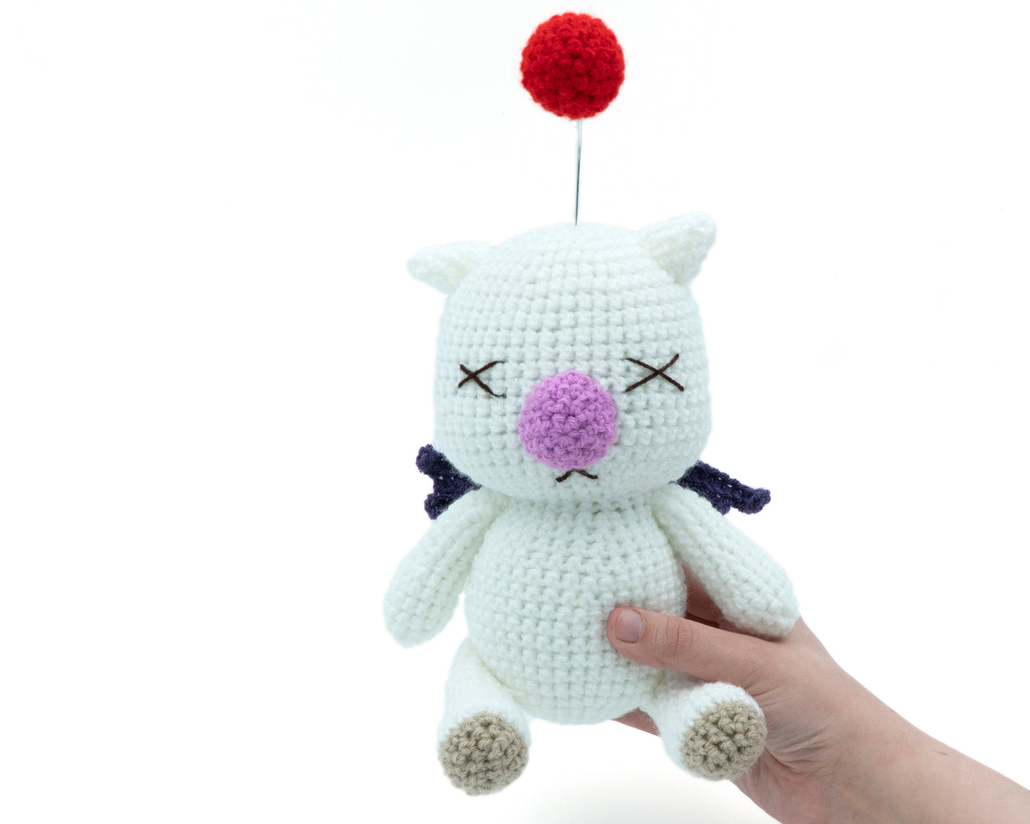 amigurumi crochet final fantasy moogle pattern in hand for size comparison