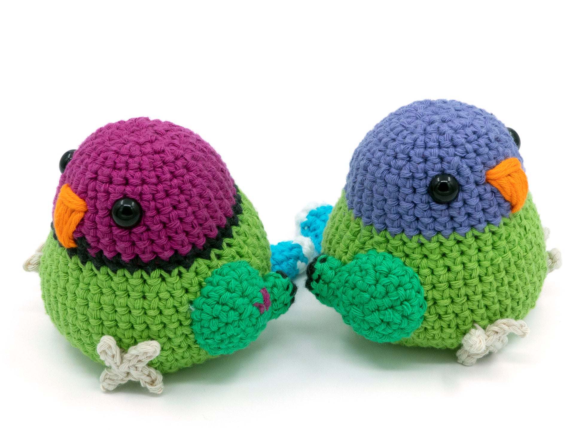 amigurumi crochet plum-headed parakeet male and female facing away from each other