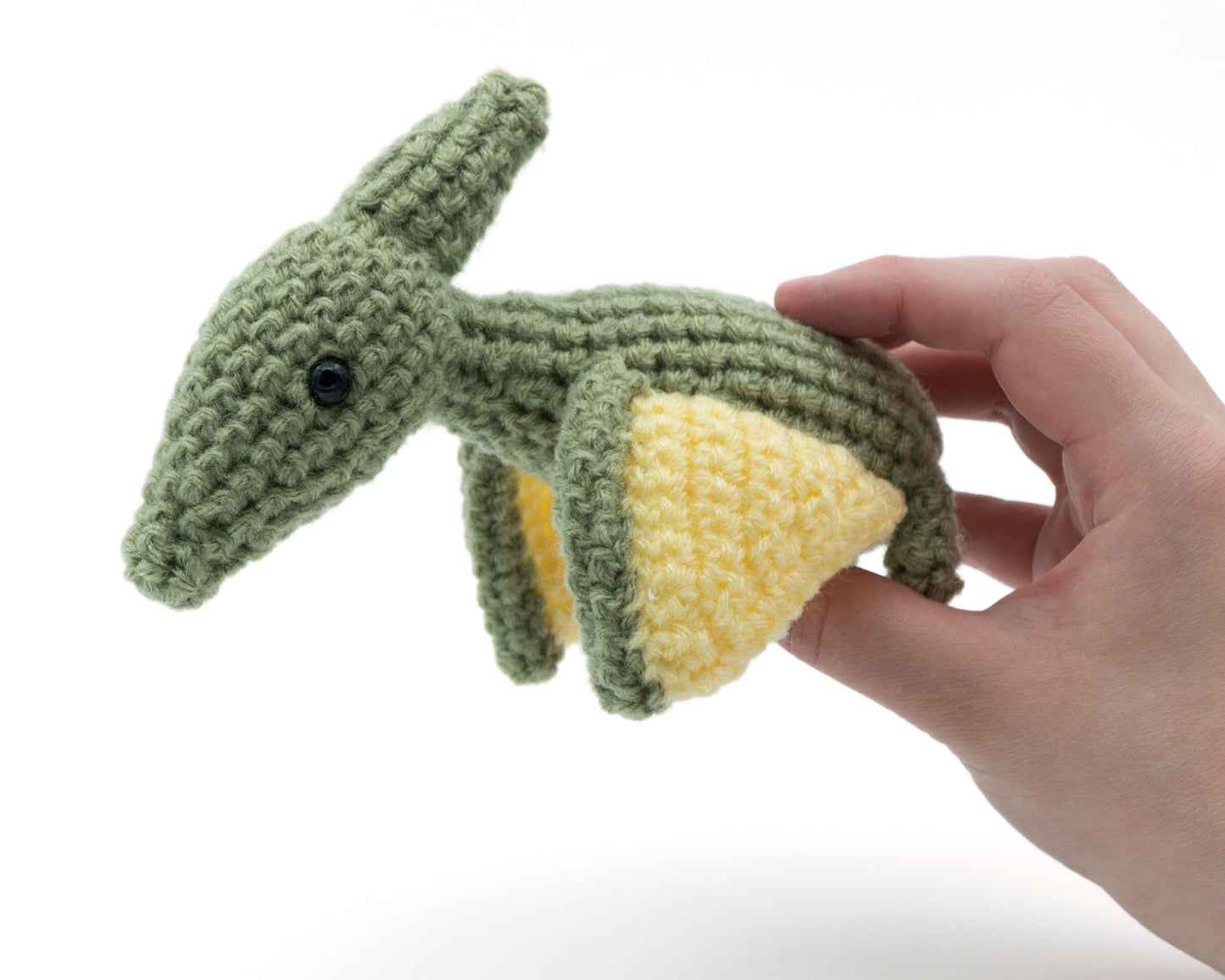 amigurumi crochet pterodactyl pattern in hand for size comparison