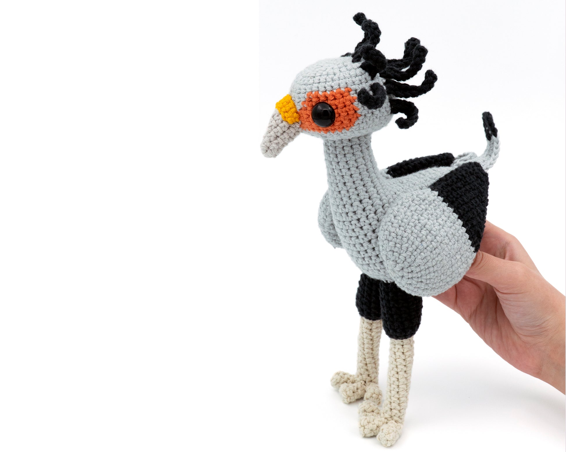 amigurumi crochet secretary bird pattern in hand for size comparison