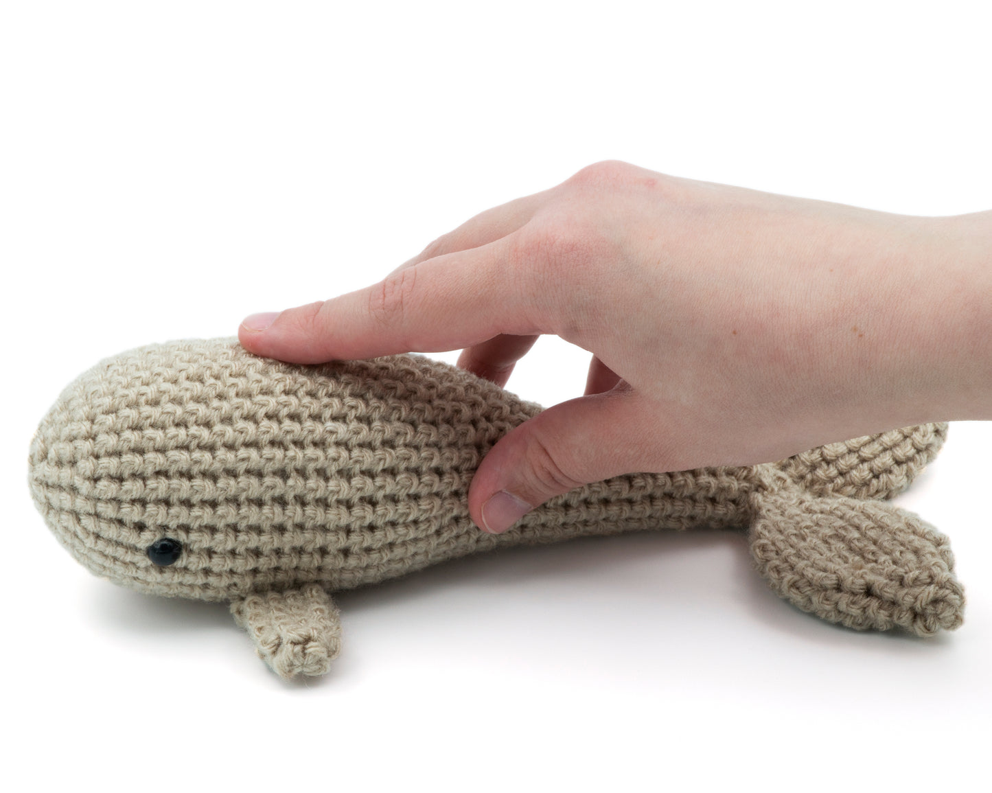 amigurumi crochet whale pattern in hand for size comparison
