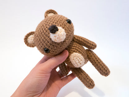 amigurumi crochet bear pattern in hand for size comparison
