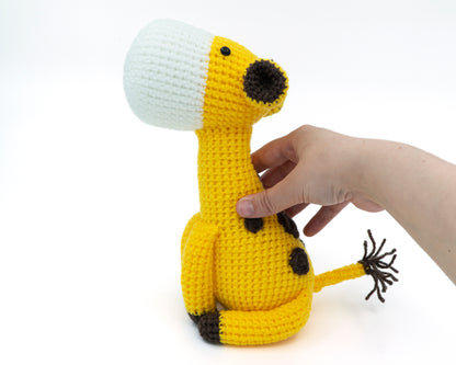 amigurumi crochet giraffe pattern in hand for size comparison