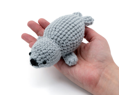 amigurumi crochet baby seal pattern in hand for size comparison