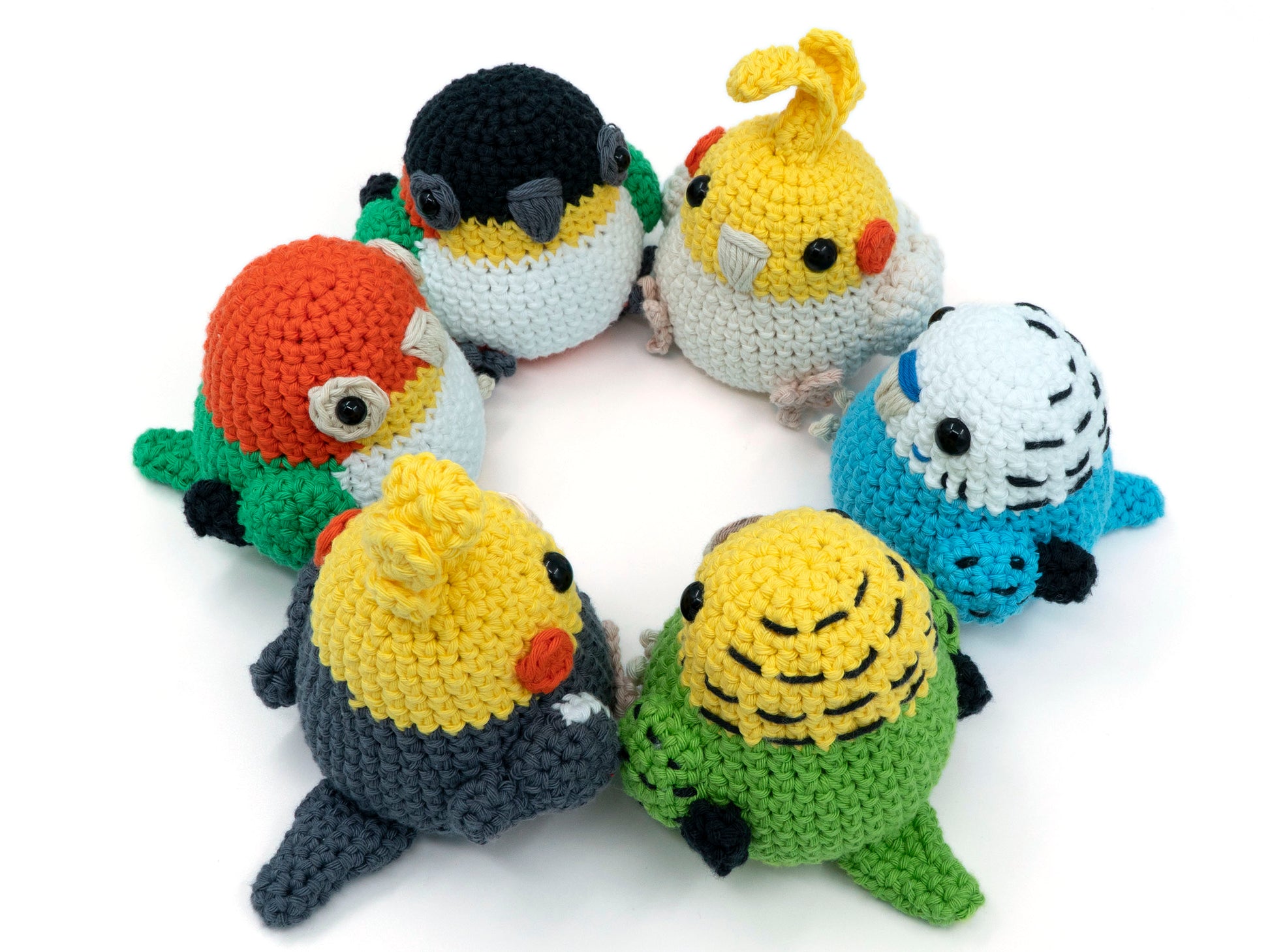 amigurumi crochet parrot pattern bundle with cockatiel budgie and caique sitting in a circle