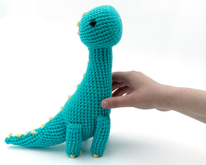 amigurumi crochet brachiosaurus dinosaur pattern in hand for size comparison
