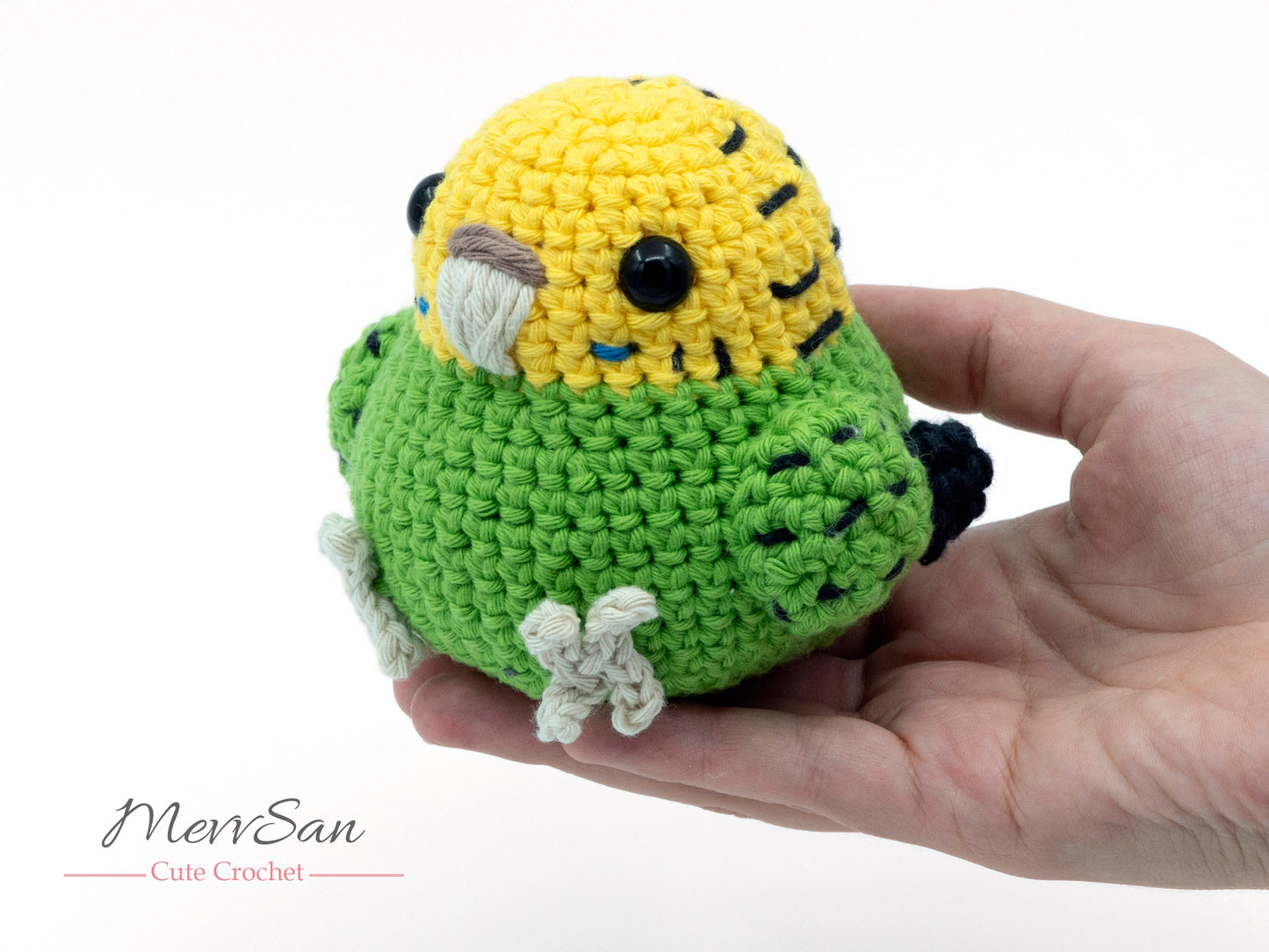 amigurumi crochet budgie pattern green parakeet in hand for size comparison