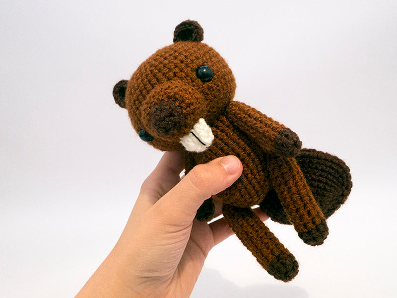 amigurumi crochet beaver pattern in hand for size comparison