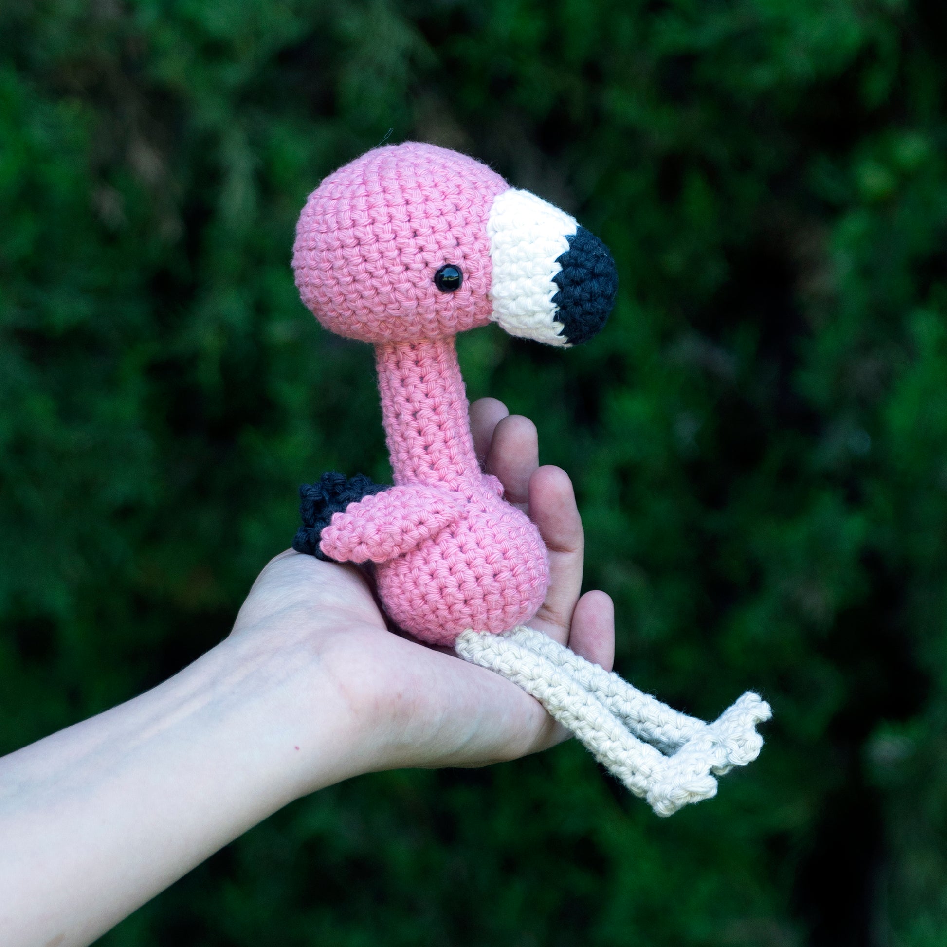 handmade crochet flamingo amigurumi plush pink bird sitting pose side view