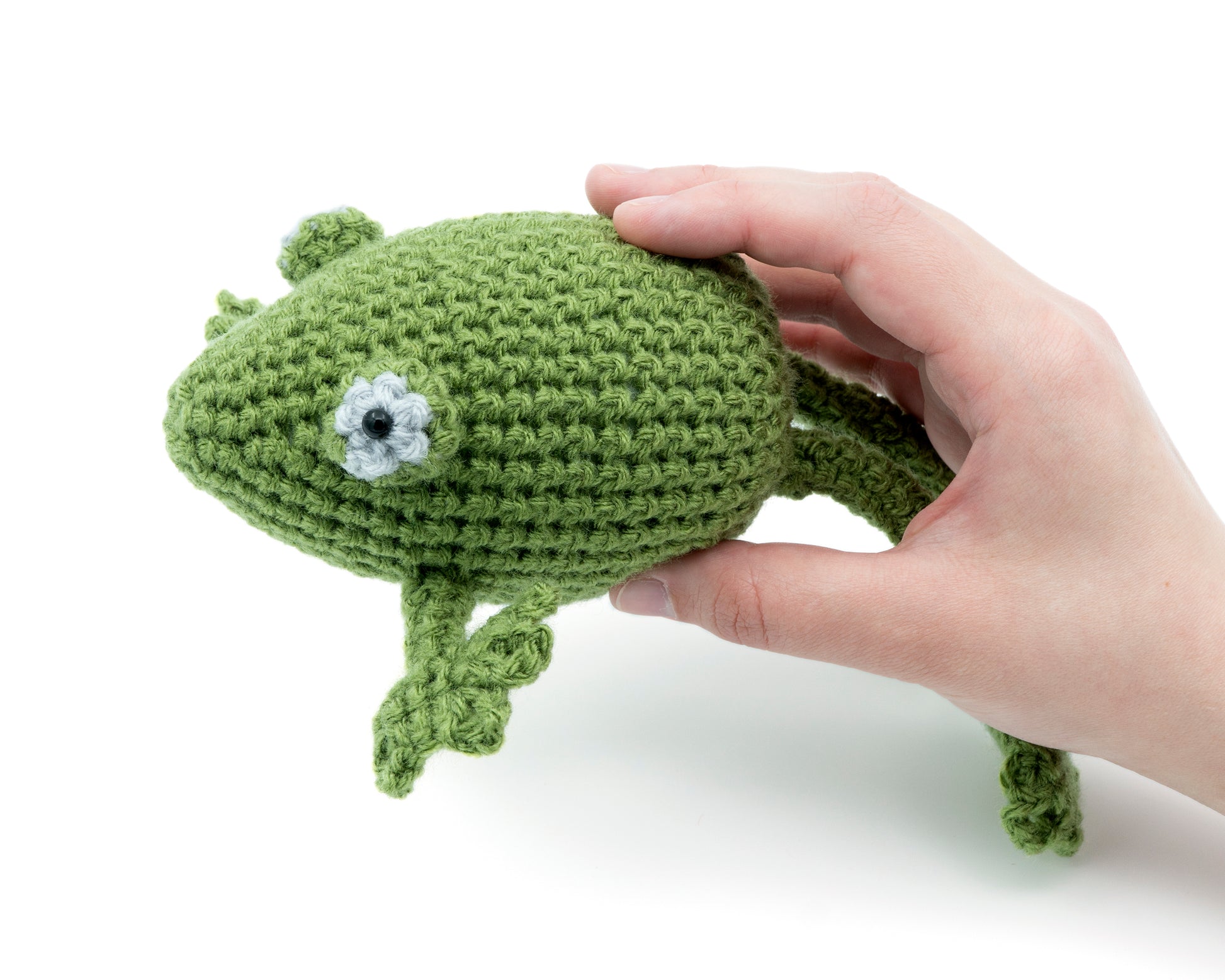 amigurumi crochet frog pattern in hand for size comparison