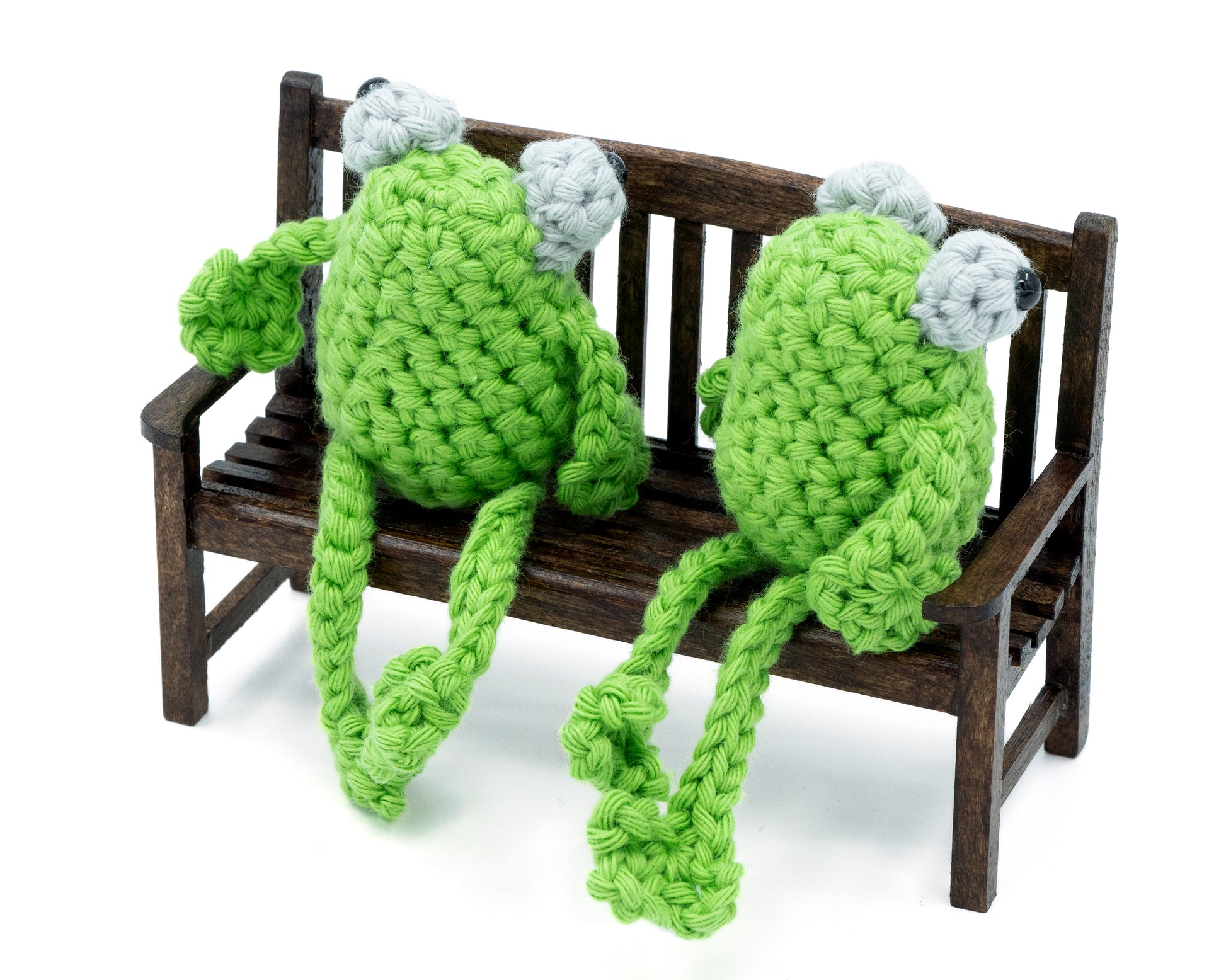 amigurumi crochet tiny frog pattern sitting in on a little bench with a friend