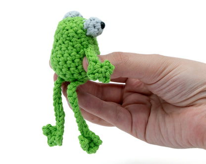 amigurumi crochet sitting frog pattern in hand for size comparison