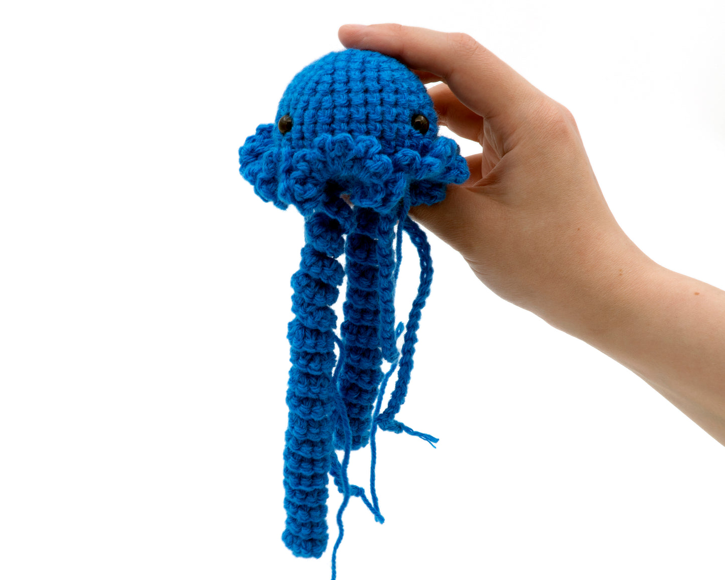 amigurumi crochet jellyfish pattern in hand for size comparison