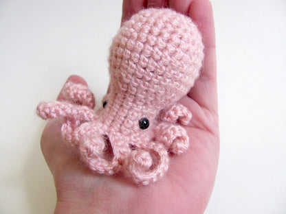 amigurumi crochet octopus pattern in hand for size comparison