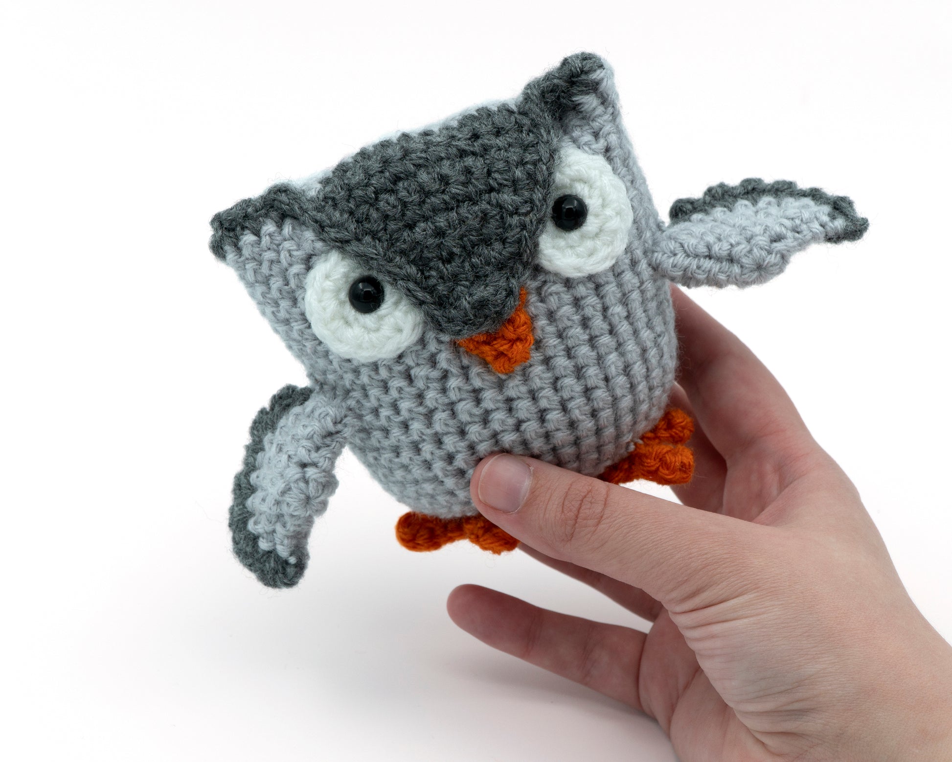 amigurumi crochet owl pattern in hand for size comparison