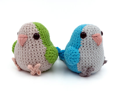 handmade crochet quaker parrot monk parakeet amigurumi plush green and blue sitting together facing away from one another