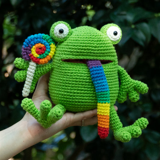 Handmade rainbow lollipop frog amigurumi plush with colorful swirl lollipop