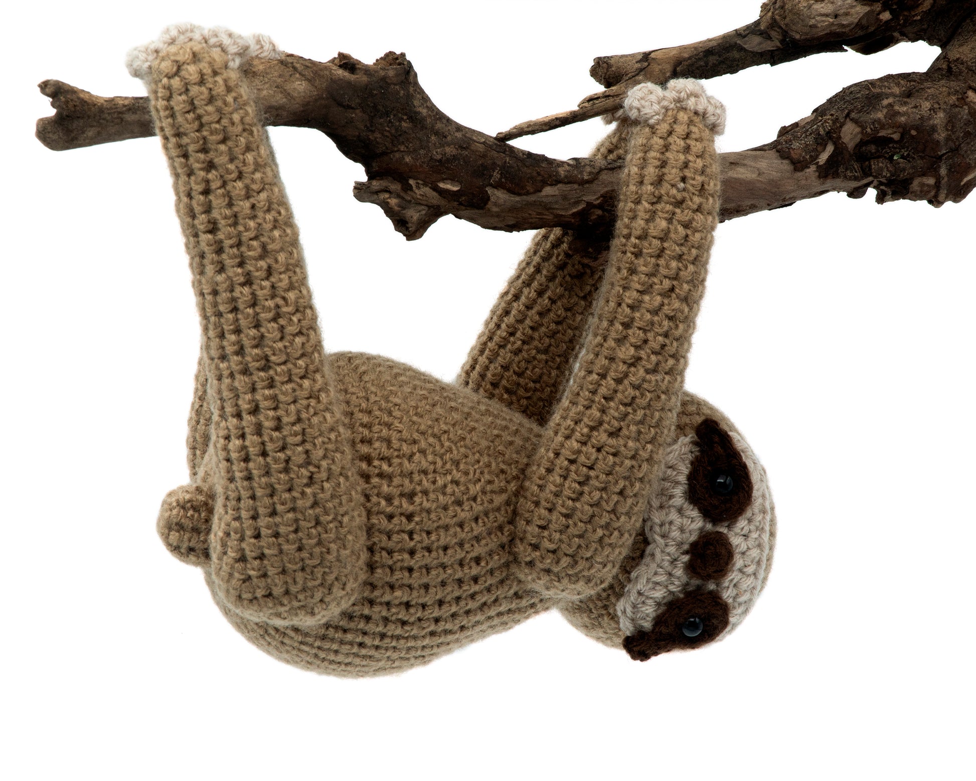 amigurumi crochet sloth  pattern hanging from a tree branch