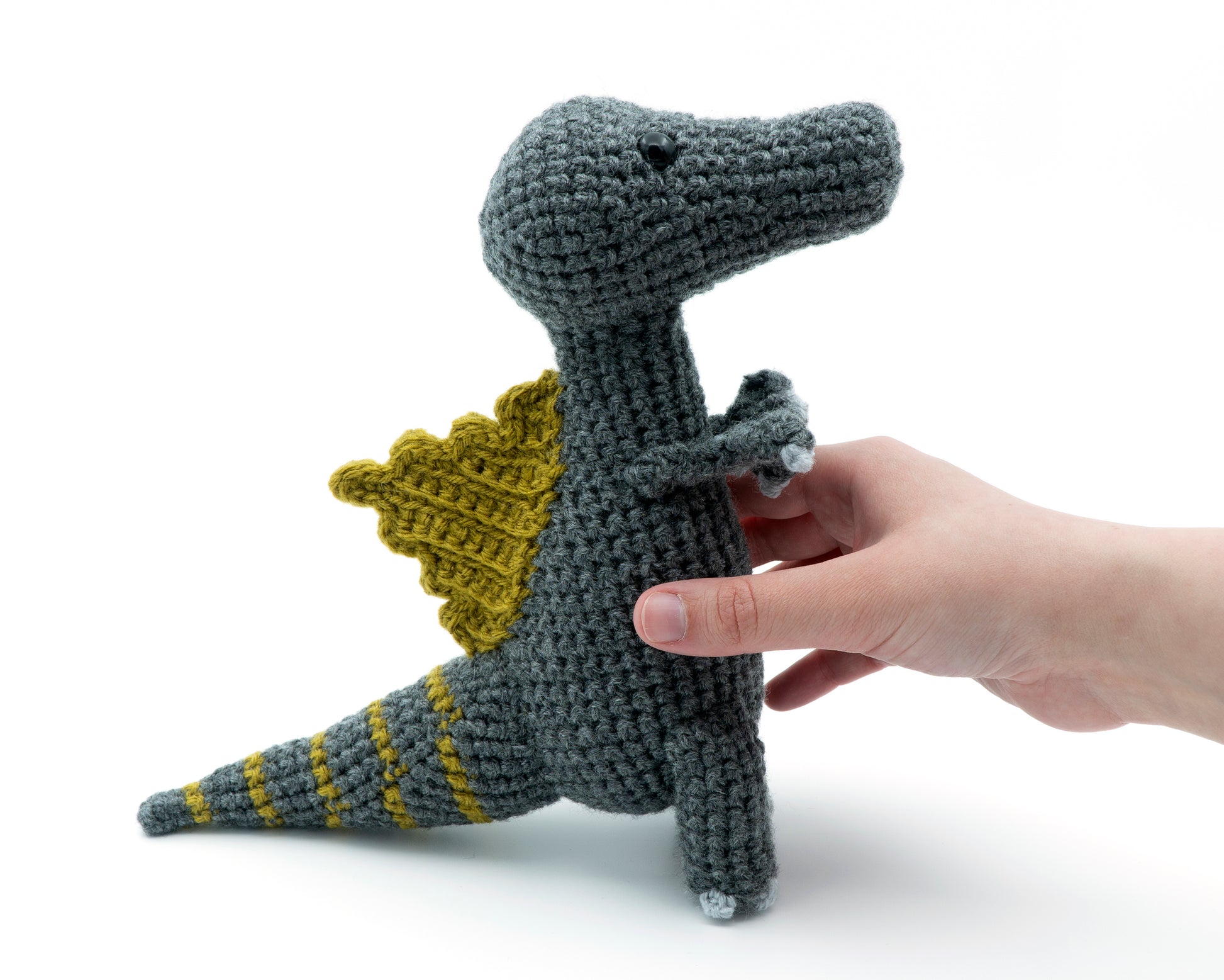 amigurumi crochet spinosaurus dinosaur pattern in hand for size comparison